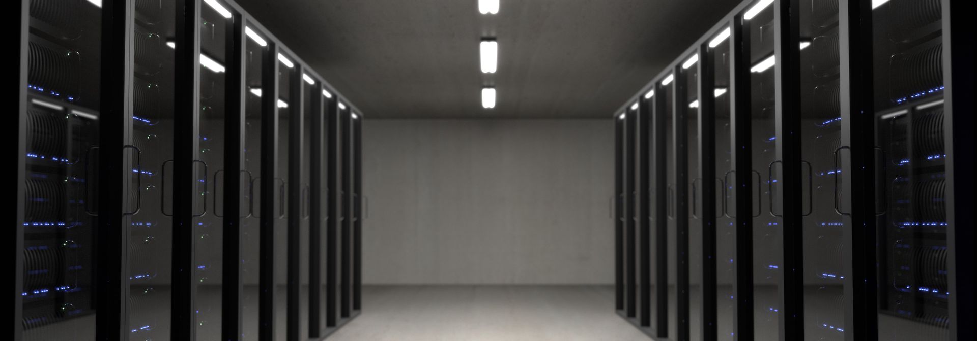 Cold aisle of a modern data hall with rows of server cabinets